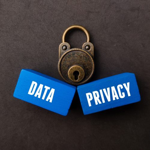 A vintage padlock and blue wooden cubes with the words DATA and  PRIVACY