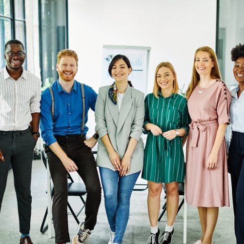 Group portrait of young businesspeople team celebrating successin the office